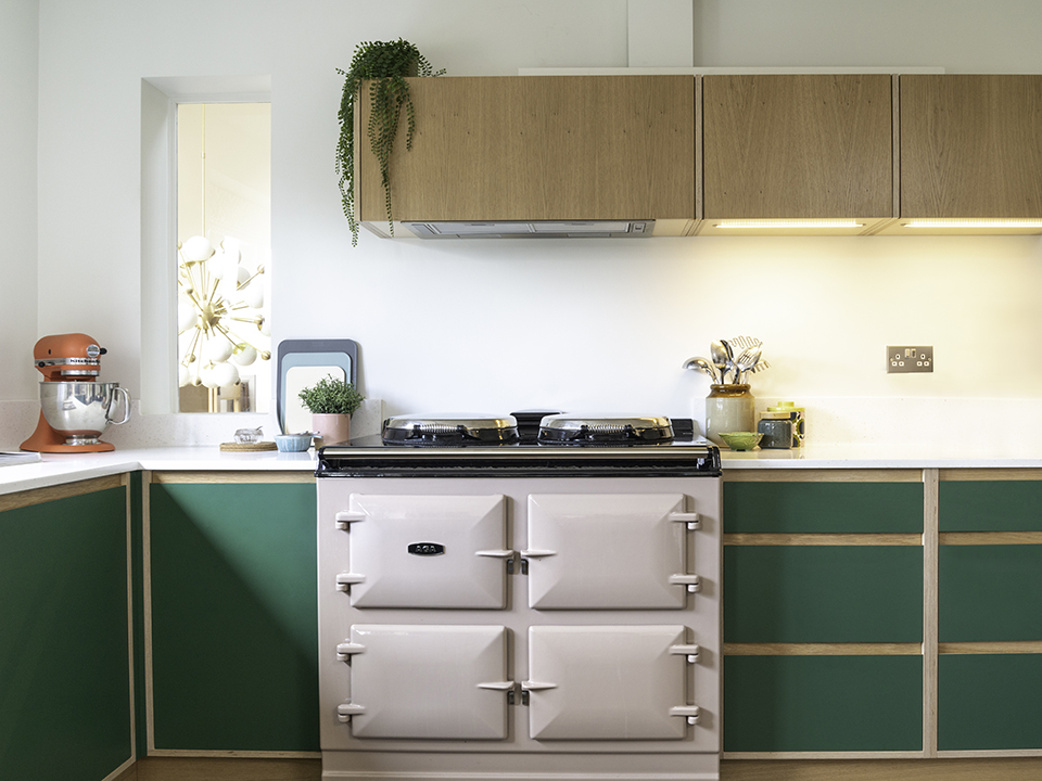 Custom kitchen with green cabinets and pink aga
