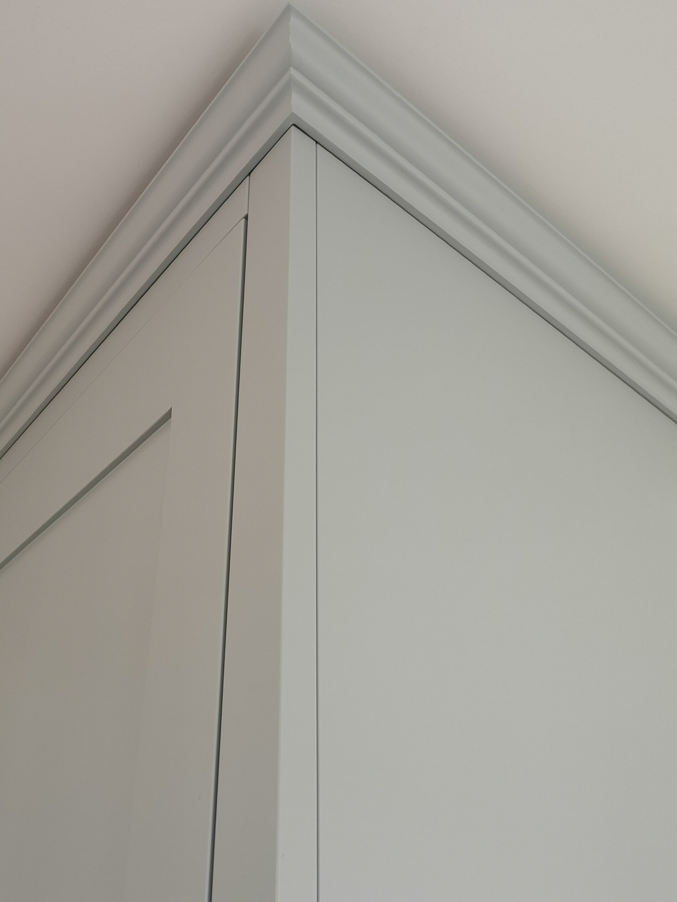 Picture shows Cornice Detailing on bespoke shaker style wardrobes.