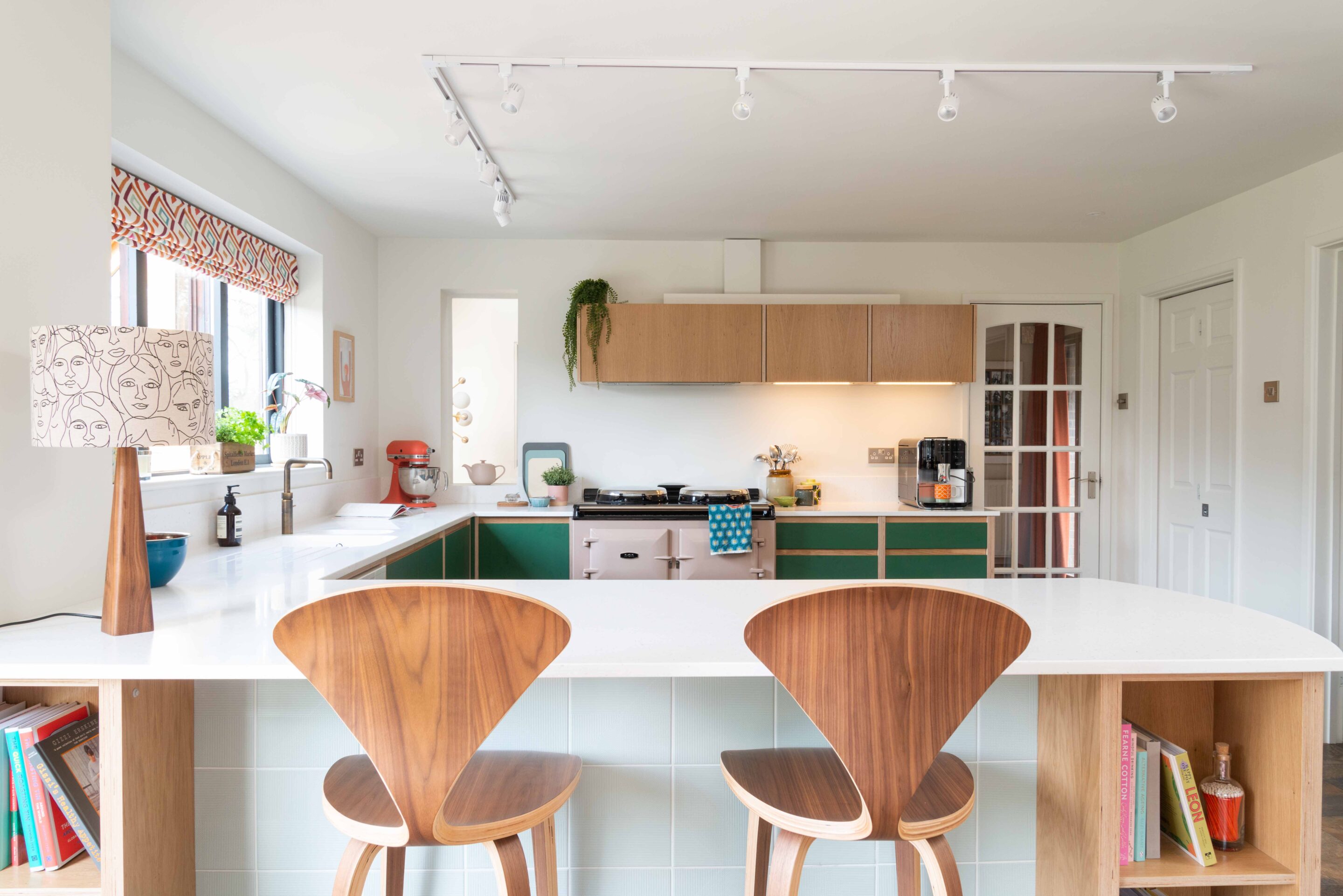 A view across the island top into the kitchen with Walnut stools