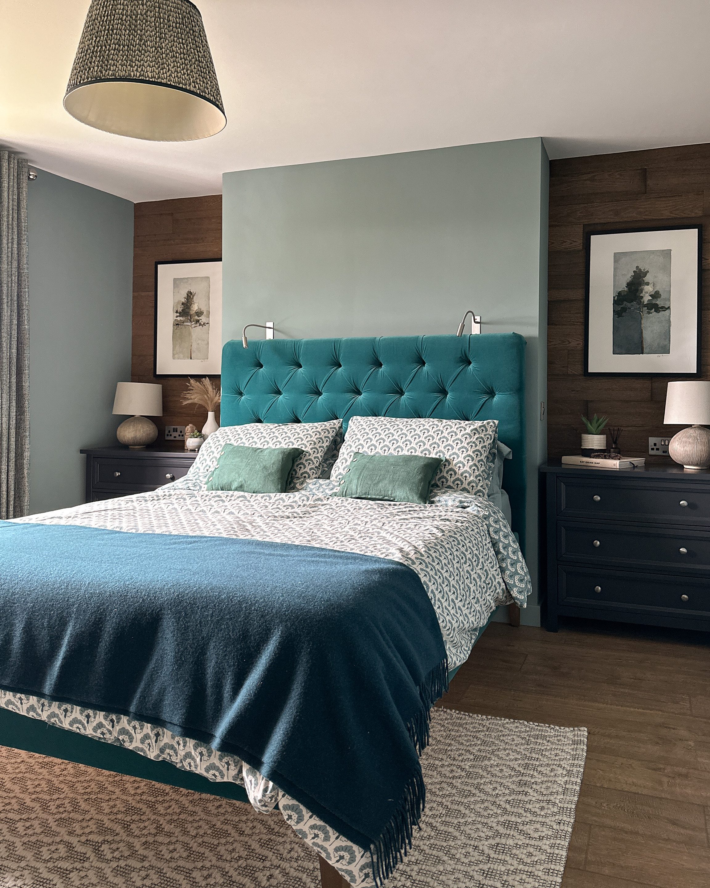 This picture shows a newly refurbished bedroom, where the fireplace has been extended to create a space for the Teal Velvet Headboard. The recesses have been panelled in Rustic Wood and the walls are painted in Farrow and Ball Oval Room Blue.