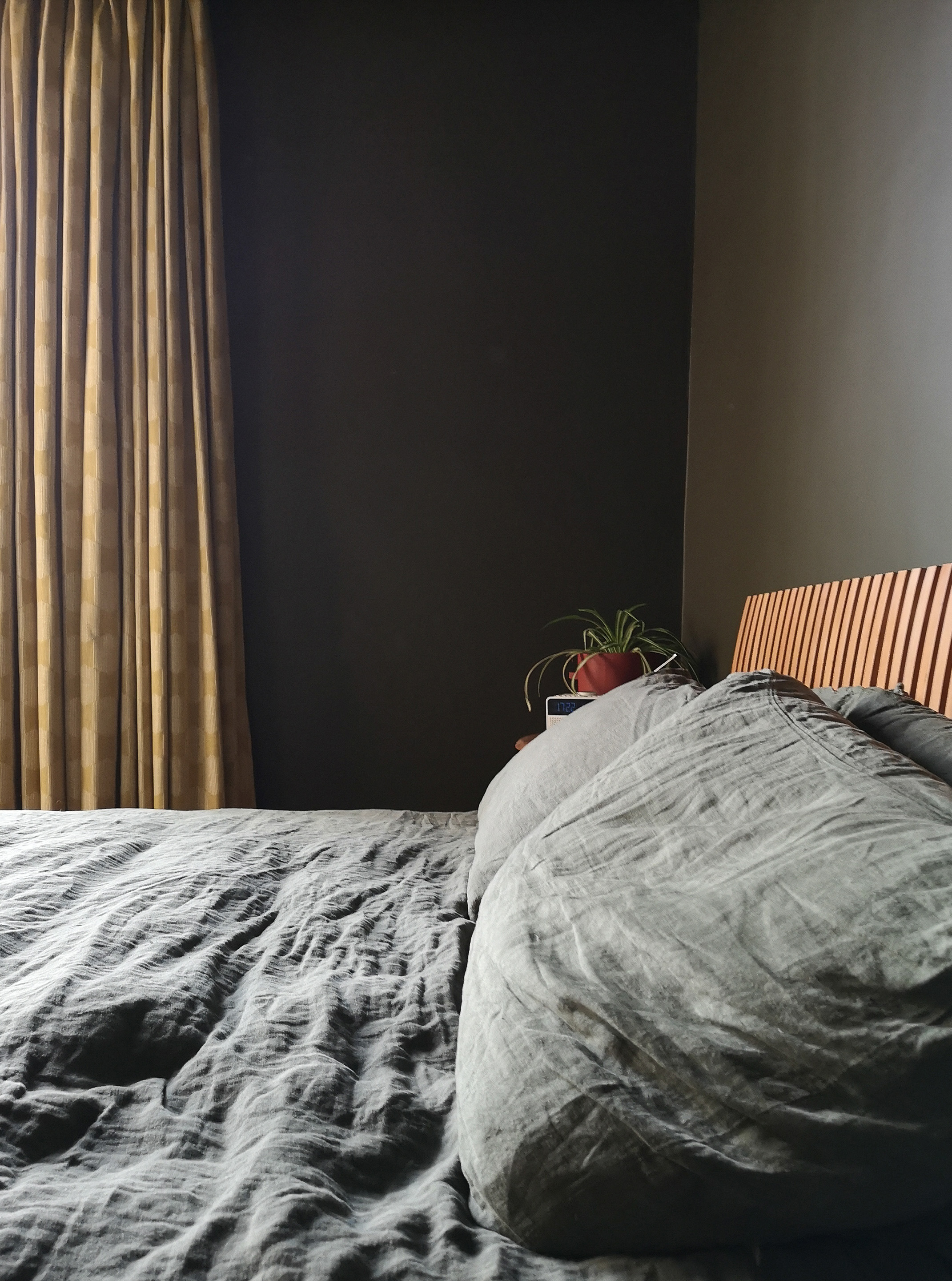 Crumpled linen bedding emphasises the relaxed comforting vibe of this dark green bedroom. Extra thick lined curtains provide complete darkness and a luxury hotel feel.