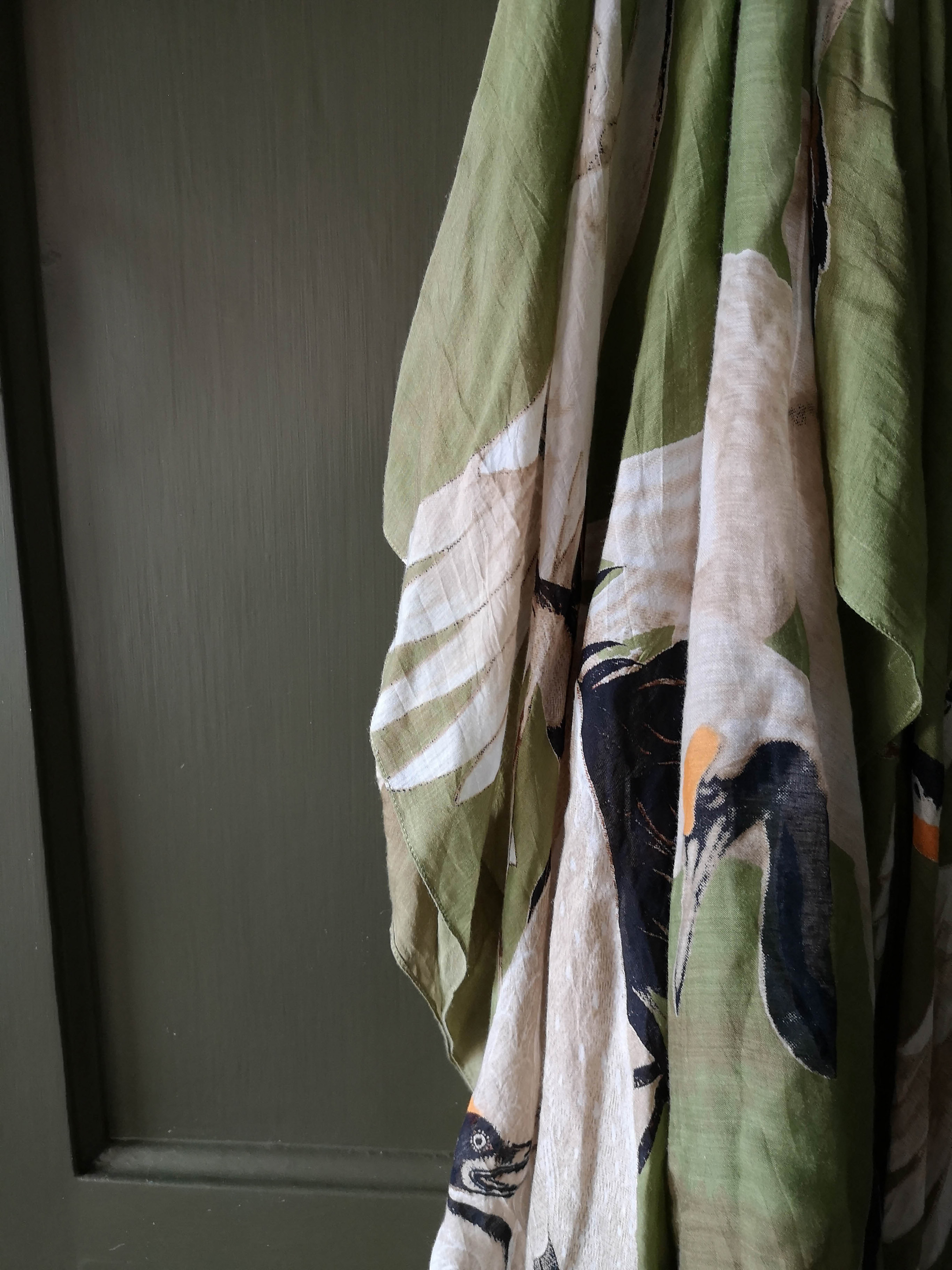 A green kimono with Stork pattern hanging on the door provided the inspiration for this dark olive green bedroom interior design near Birmingham.