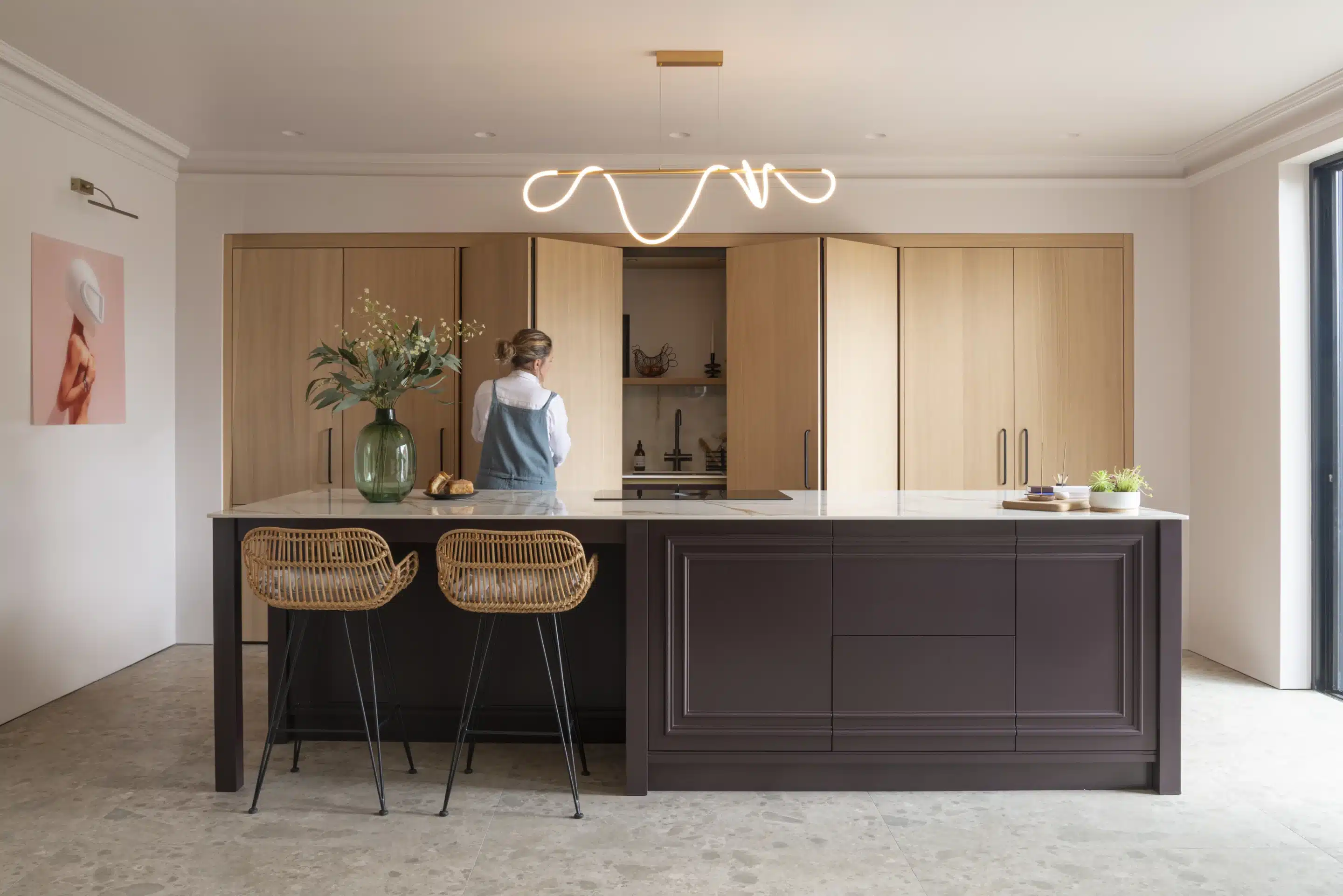 The bi-folding pocket doors being opened to reveal the wet area of the kitchen.