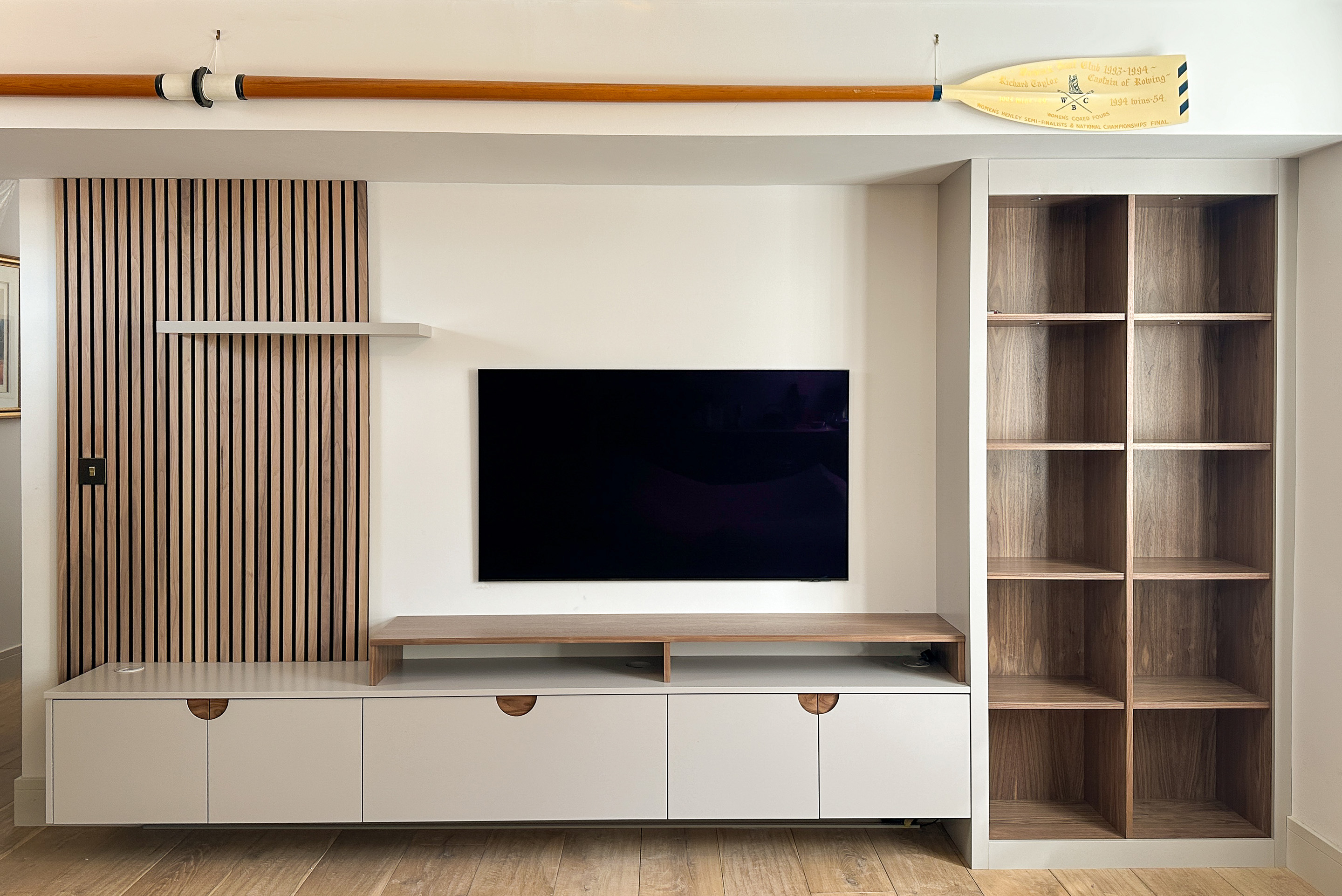 Bespoke media wall in walnut with slat panelling and integrated lighting