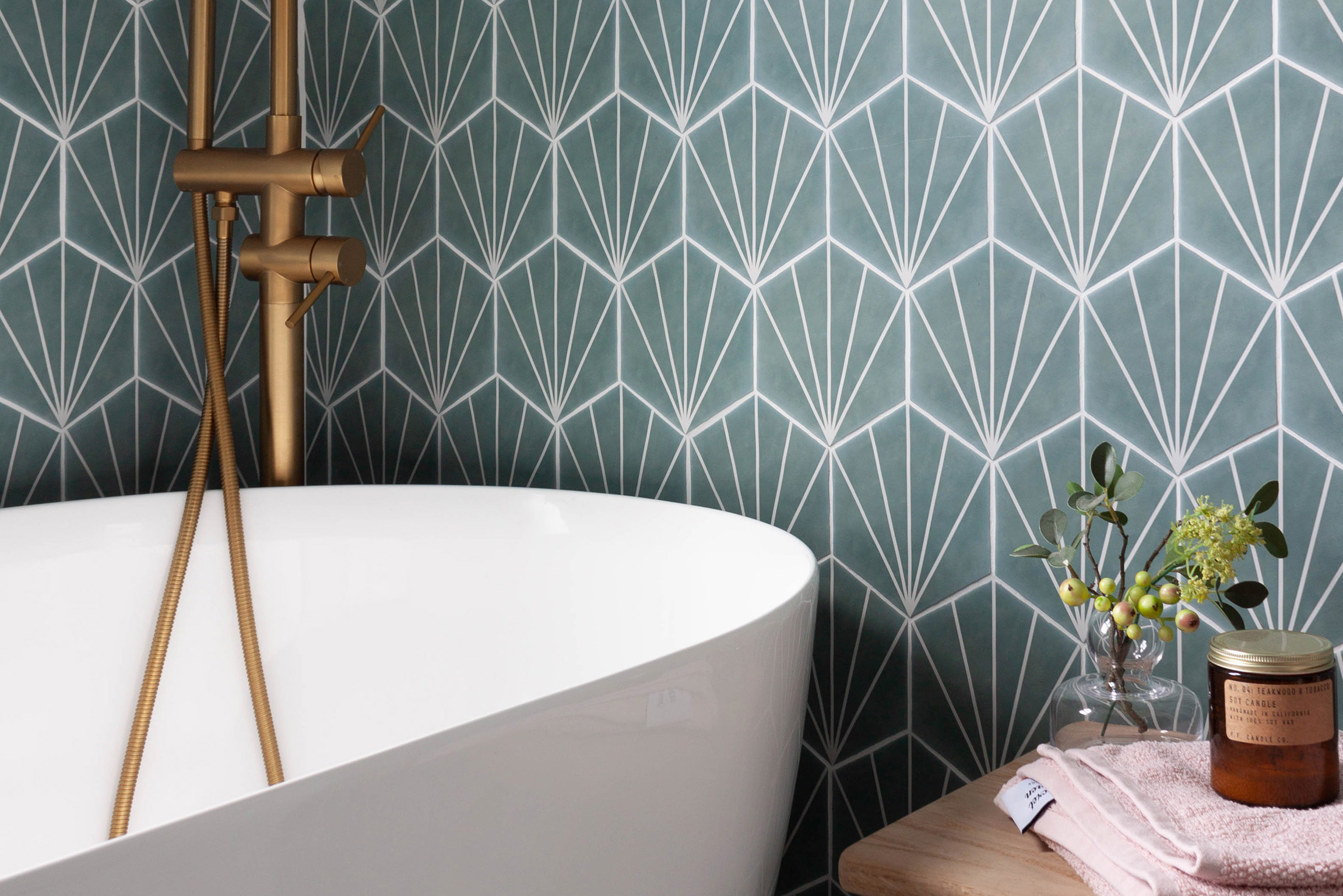 A victorian bathroom with a contemporary design including hexagonal tiles and minimalist free-standing bath