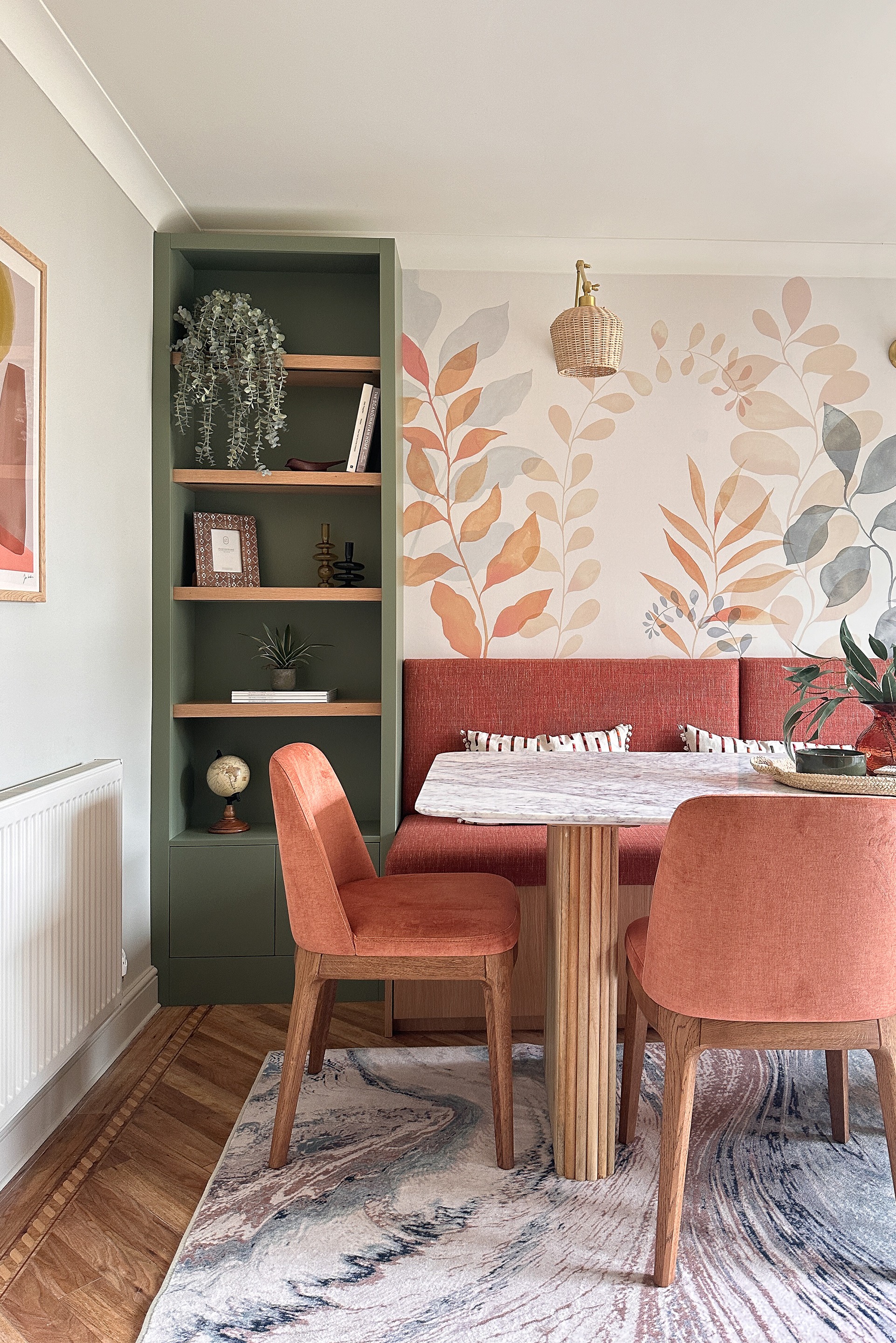 a newly redesigned dining room with dining table, upholstered chairs and bespoke bench seating and book cases at either side