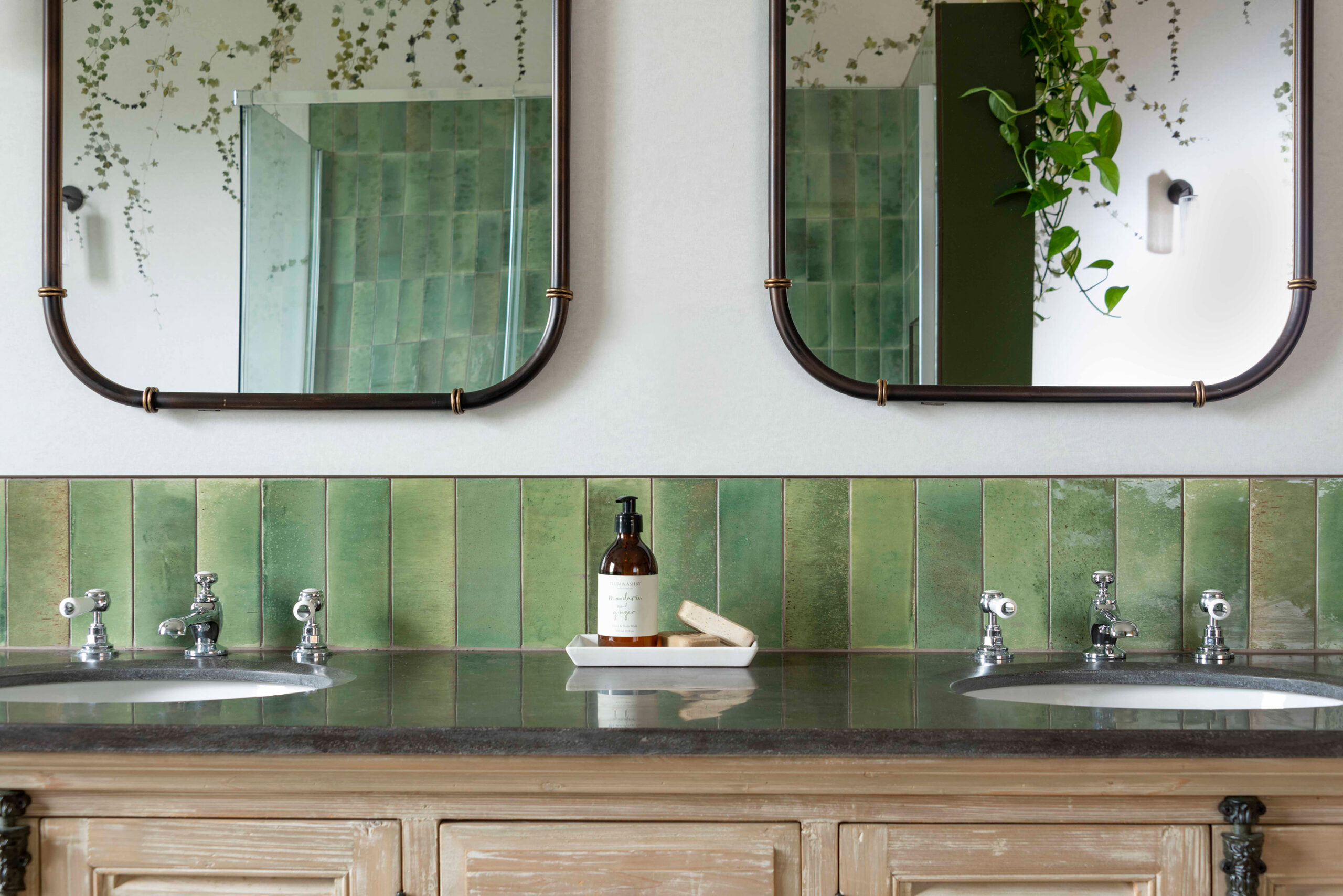 Reflections of polished black marble vanity surface and mirror details.