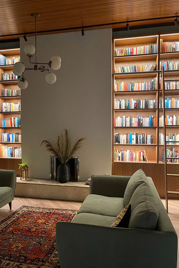 large walnut bookcases with lighting and library ladder<br />
