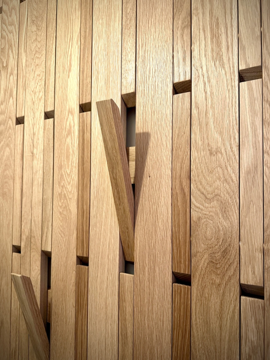 A wall to wall piano key coat rack for a bespoke boot room