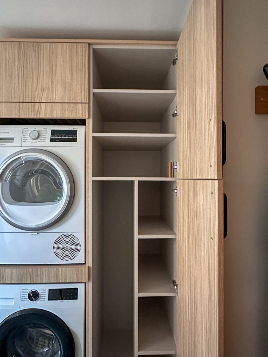 A bespoke utility room with storage tailored for upright appliances