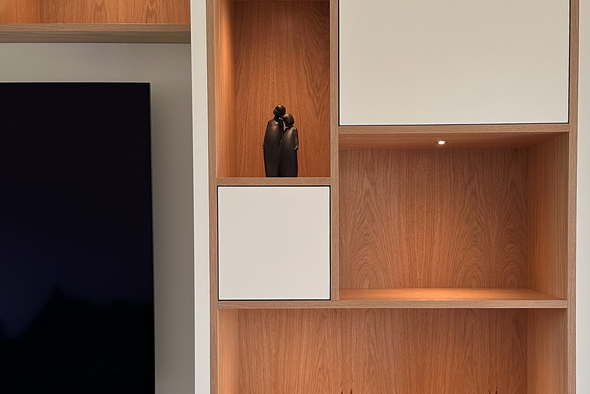 A bespoke media wall in Oak Veneer and Spray Finished in Little Greene Portland Stone