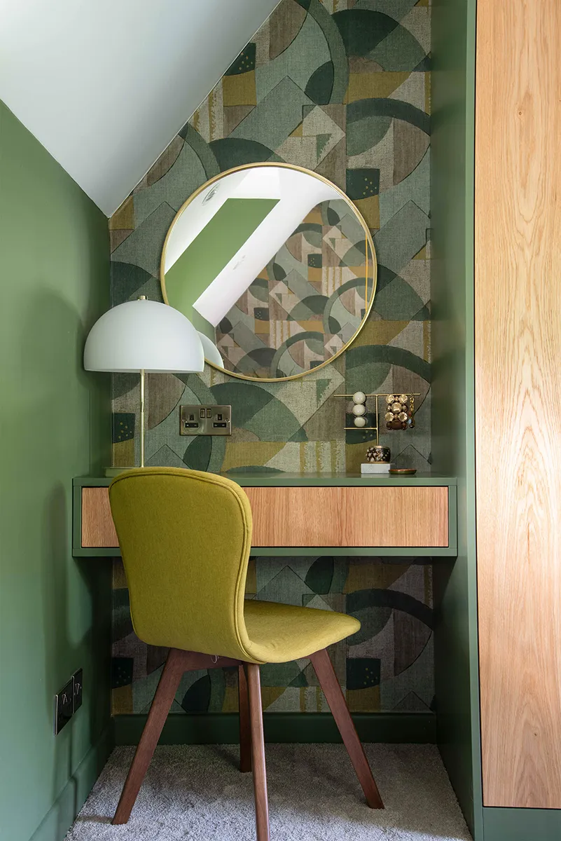 Bespoke Oak and Green dressing table fitted beneath a sloping ceiling, with round mirror and integrated storage.