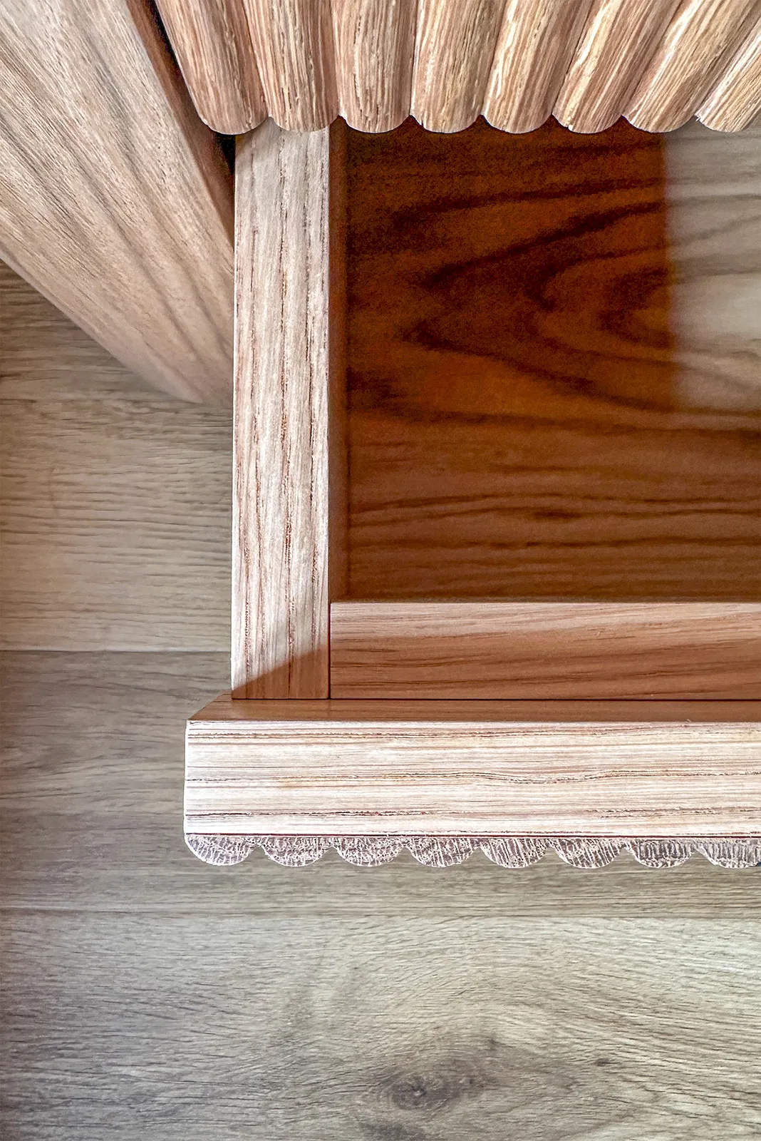 Close-up showing the reeded oak detailing and craftsmanship of the bespoke bedroom cabinetry