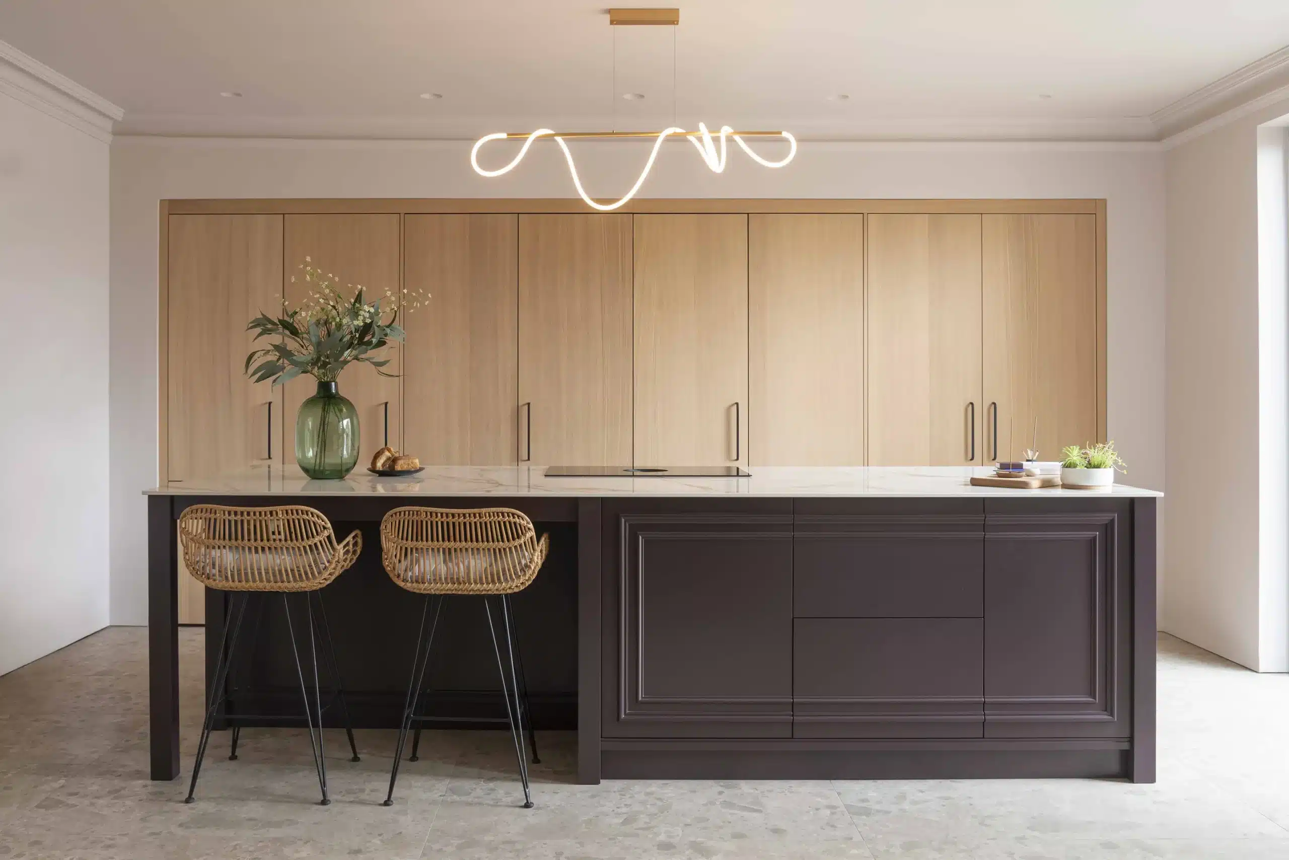 Contemporary bespoke kitchen with full-height oak cabinetry and a dark painted island in a Cheltenham home.